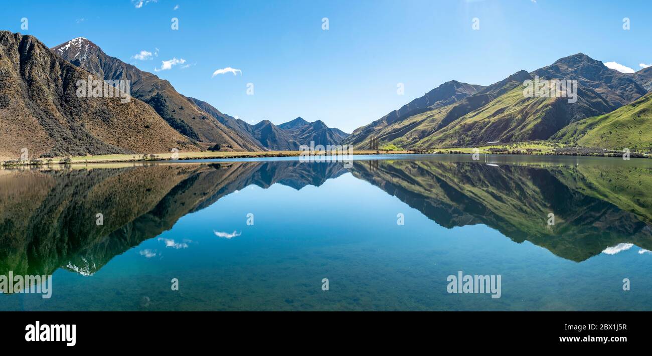 Panorama, mountains reflecting in lake, Moke Lake near Queenstown, Otago Region, Southland, New Zealand Stock Photo