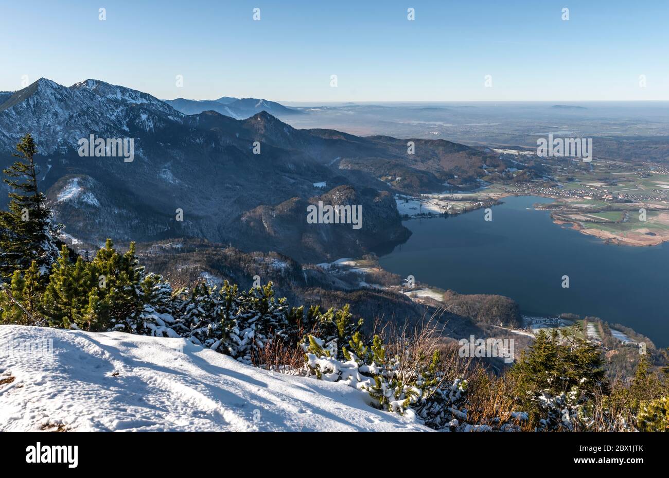 View from Jochberg to Lake Kochel in winter with snow, left Herzogstand, Alpine foreland, Upper Bavaria, Bavaria, Germany Stock Photo
