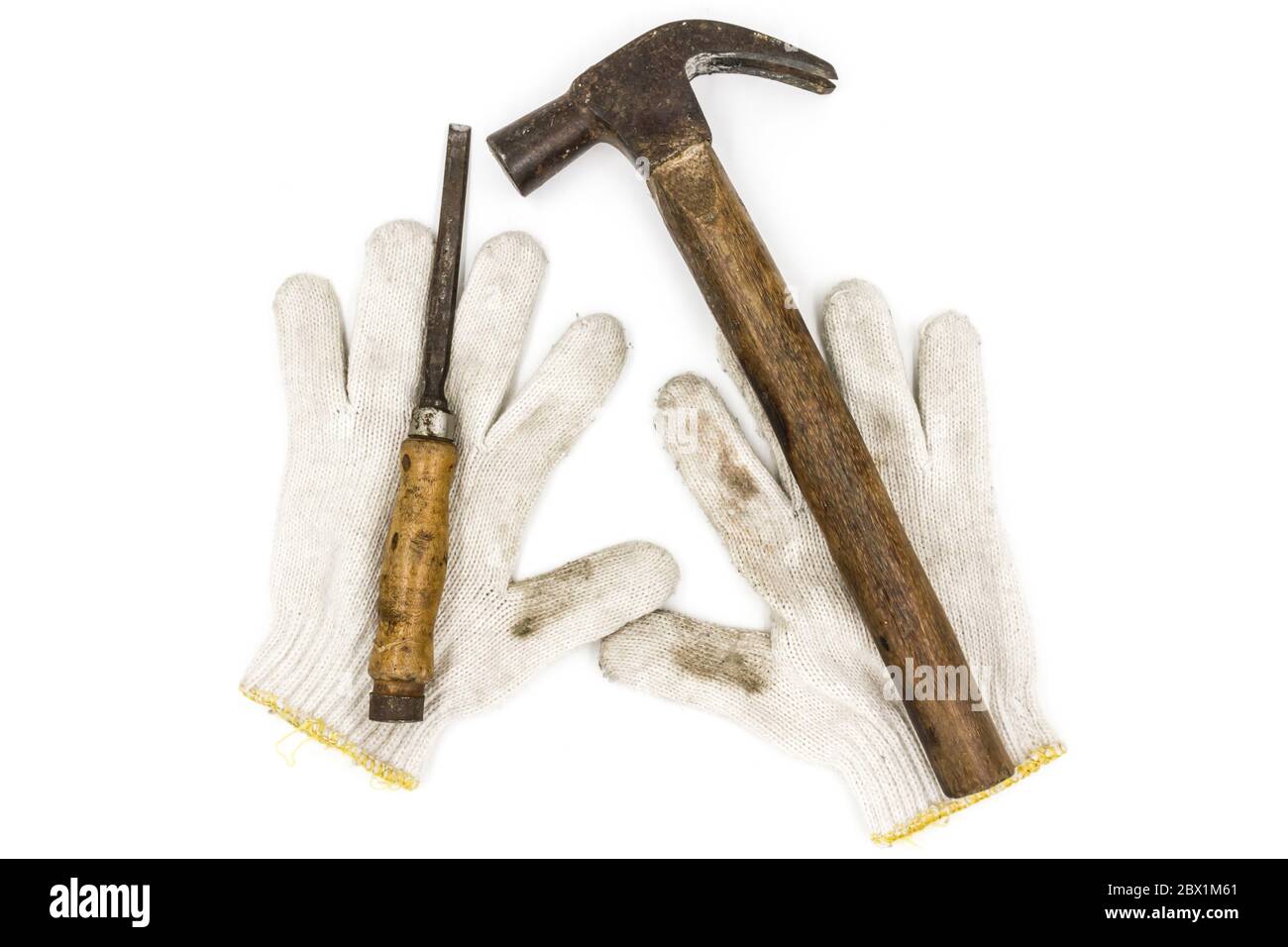 Old Tools include gloves, hammer and chisel. Stock Photo