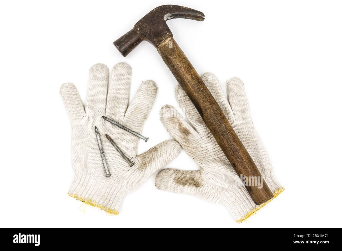 Old tools include Gloves, hammer and nails Stock Photo