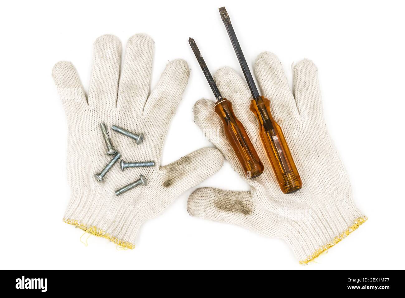Old tools include Gloves, screwdrivers and nut Stock Photo