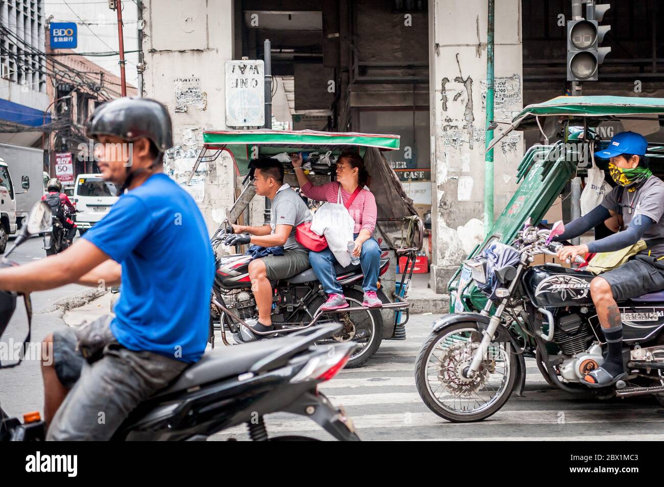 Traffic pauses at a busy junction in the China Town, Binondo District of Manila, The Philippines. Stock Photo