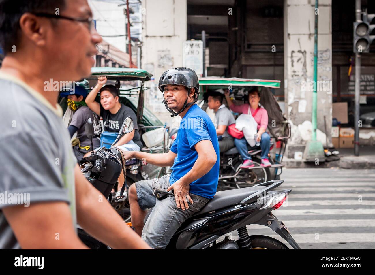 Traffic pauses at a busy junction in the China Town, Binondo District of Manila, The Philippines. Stock Photo