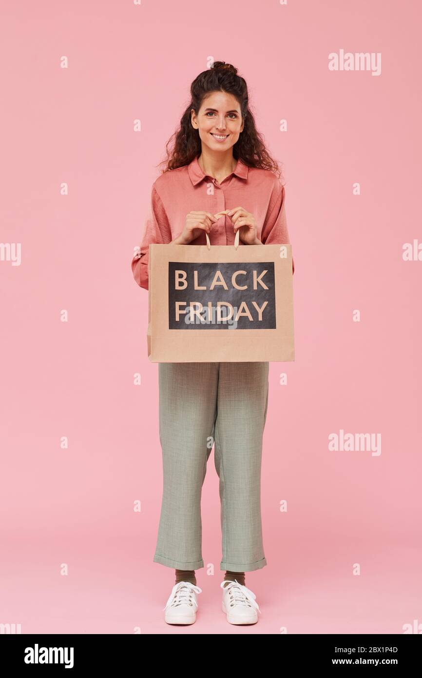 Portrait of beautiful woman doing Black Friday shopping she standing and smiling at camera Stock Photo
