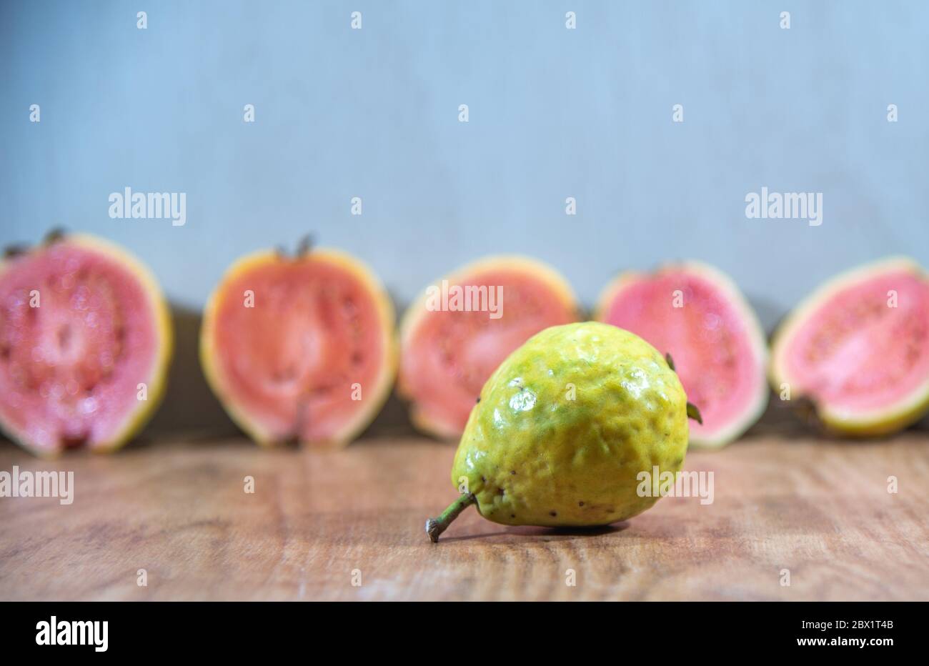 Guava fruits broken in half. Tropical fruits. Guavas in halves. Source