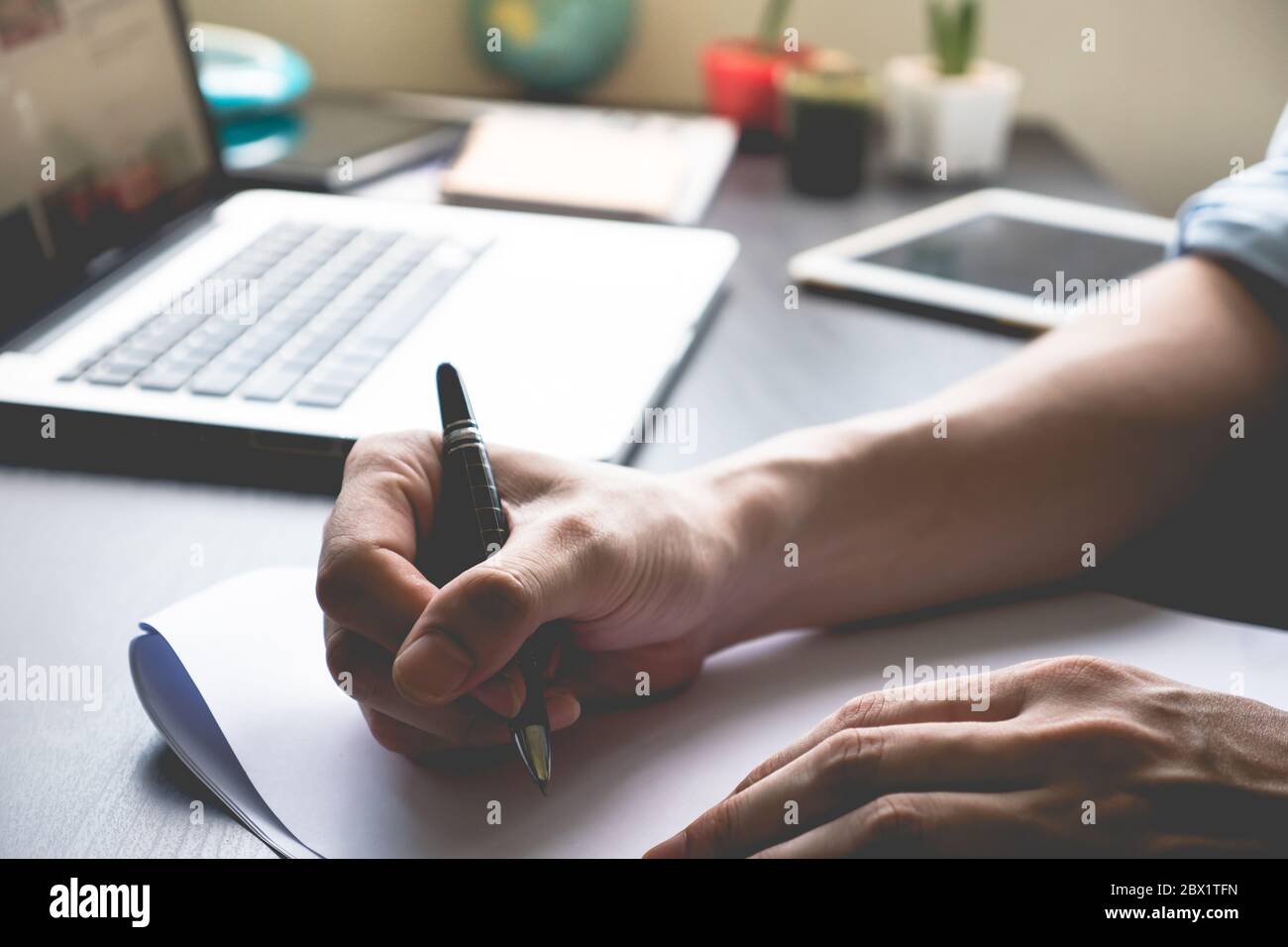 Close up of male hands writing on paper on his office desk Stock Photo ...