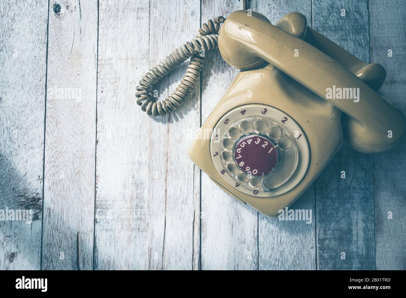Top view of Old telephone on wooden table background, Vintage tone ...