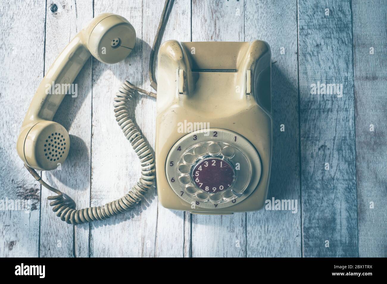 Top view of Old telephone on wooden table background, Vintage tone ...