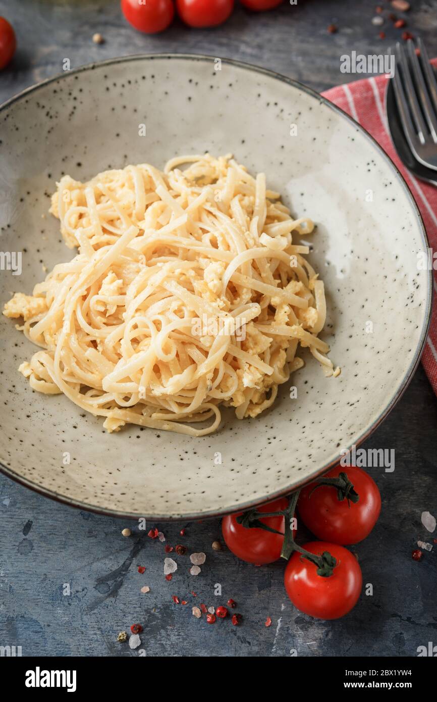 Pasta Linguine with scrambled eggs and parmesan cheese. Traditional