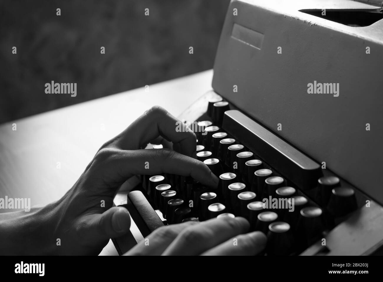 Close up of Male hands typing on the old typewriter. Black and White tone Stock Photo