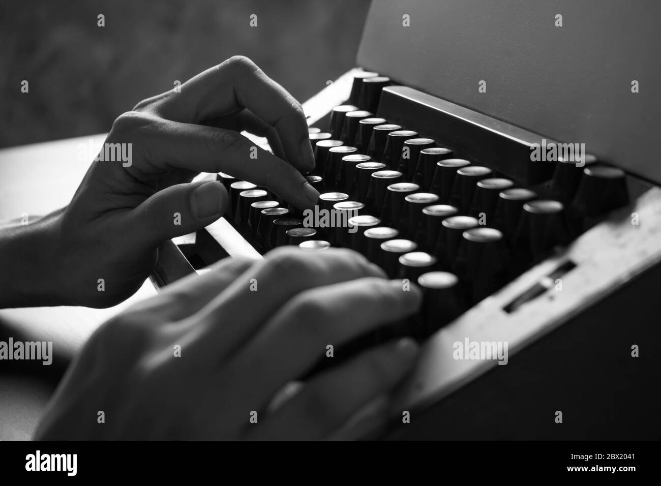 Close up of Male hands typing on the old typewriter. Black and White tone Stock Photo