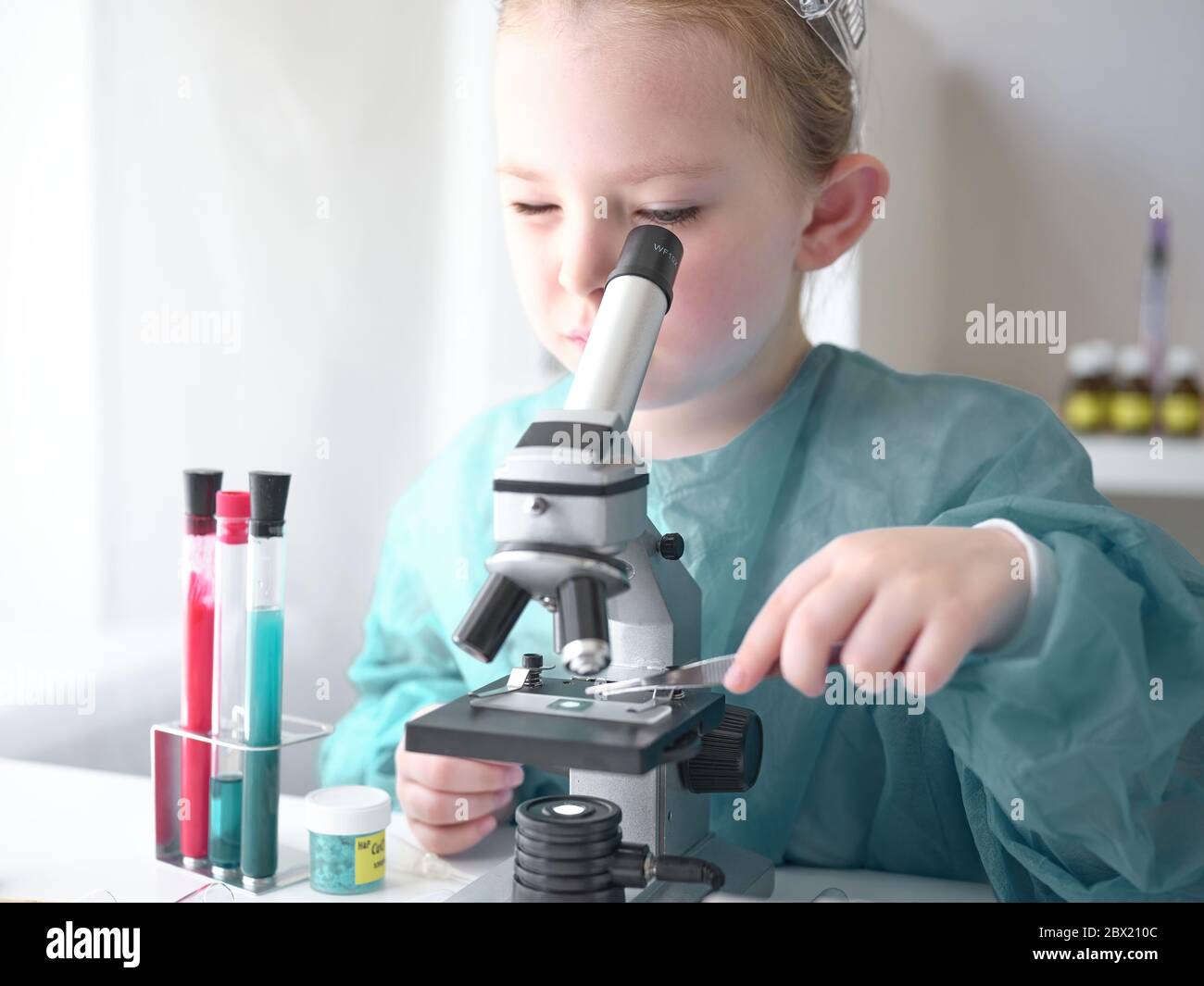 A little girl does scientific work in her home laboratory. The concept is  the children of the future. High quality photo Stock Photo - Alamy
