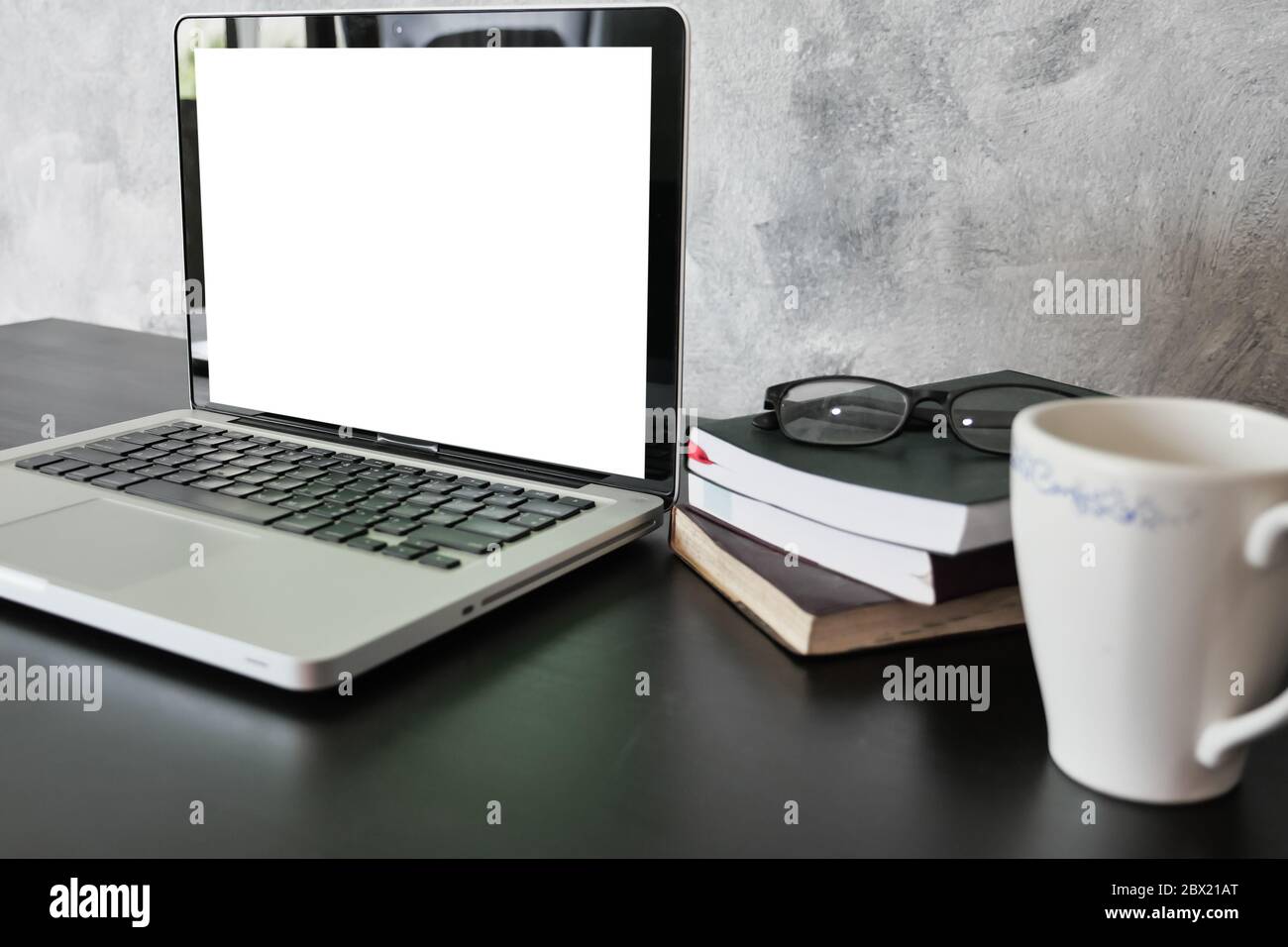 Laptop with white screen monitor on the desk Stock Photo - Alamy