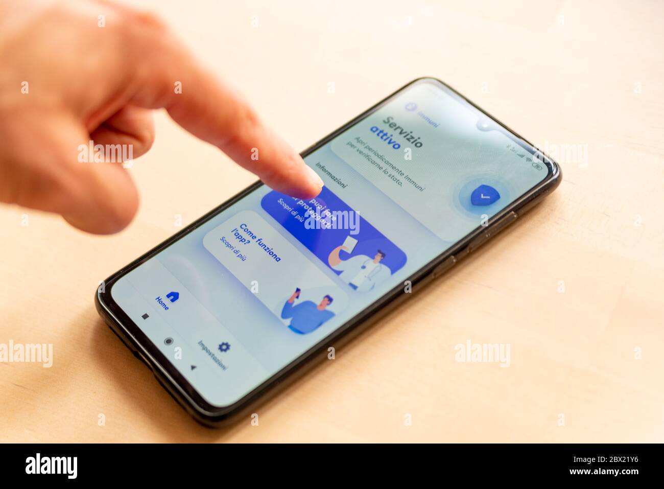 Rome, Italy - 1 june 2020: close up of hand with immuni mobile contact tracing app, technology used to control the coronavirus pandemic spread Stock Photo