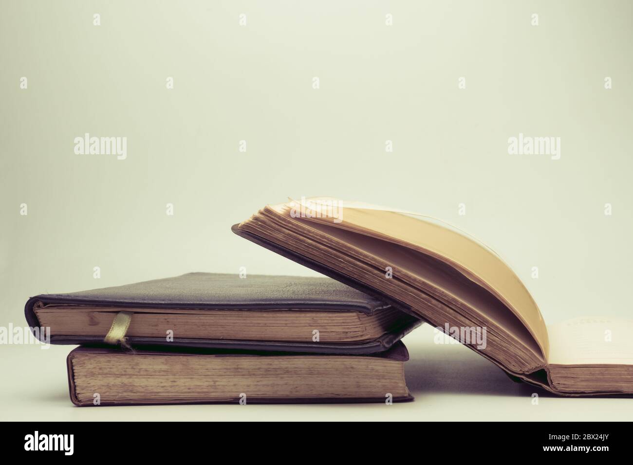 A stack of old books with vintage background Stock Photo - Alamy