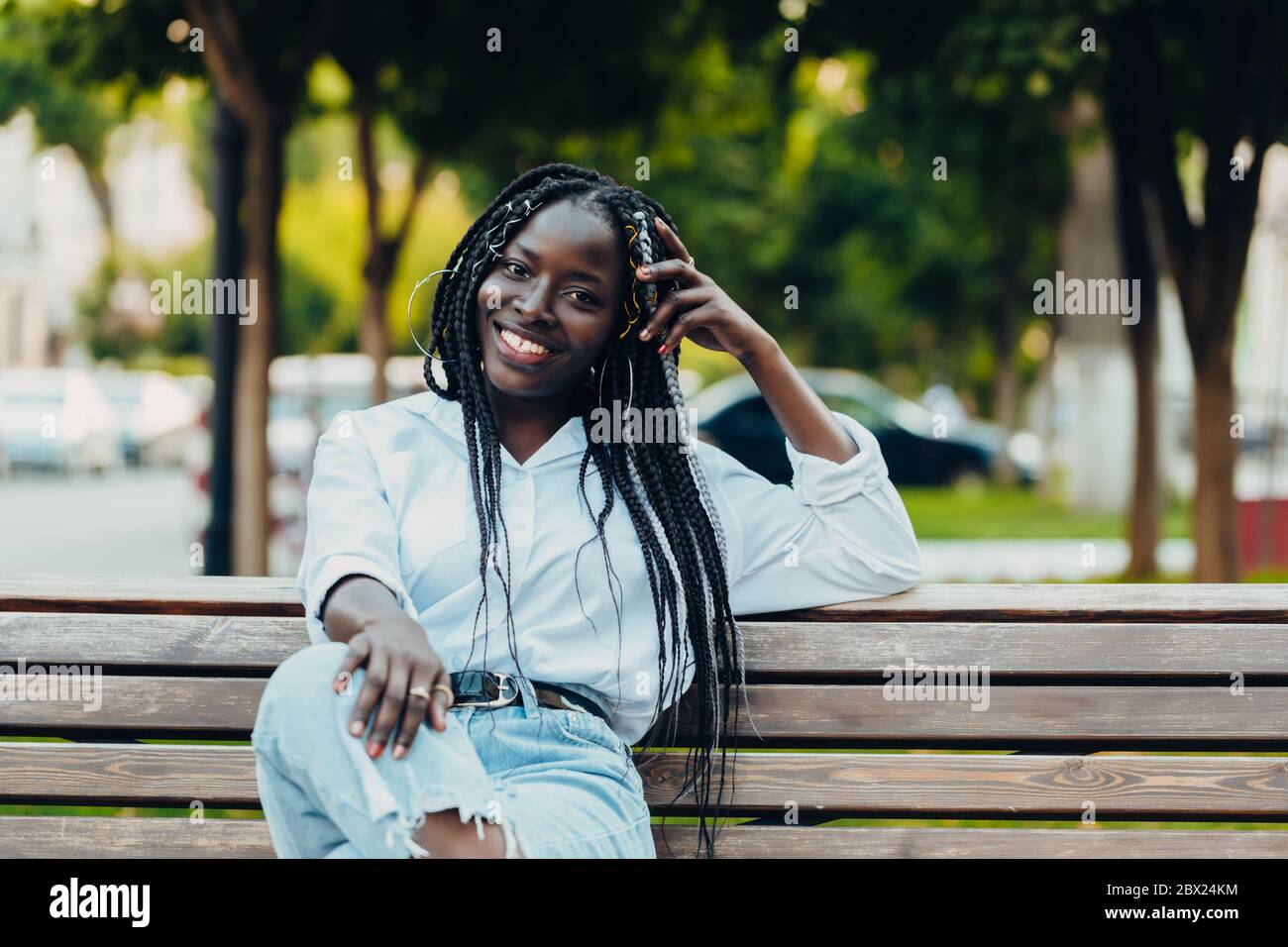 African girl sitting on bench hi-res stock photography and images - Alamy