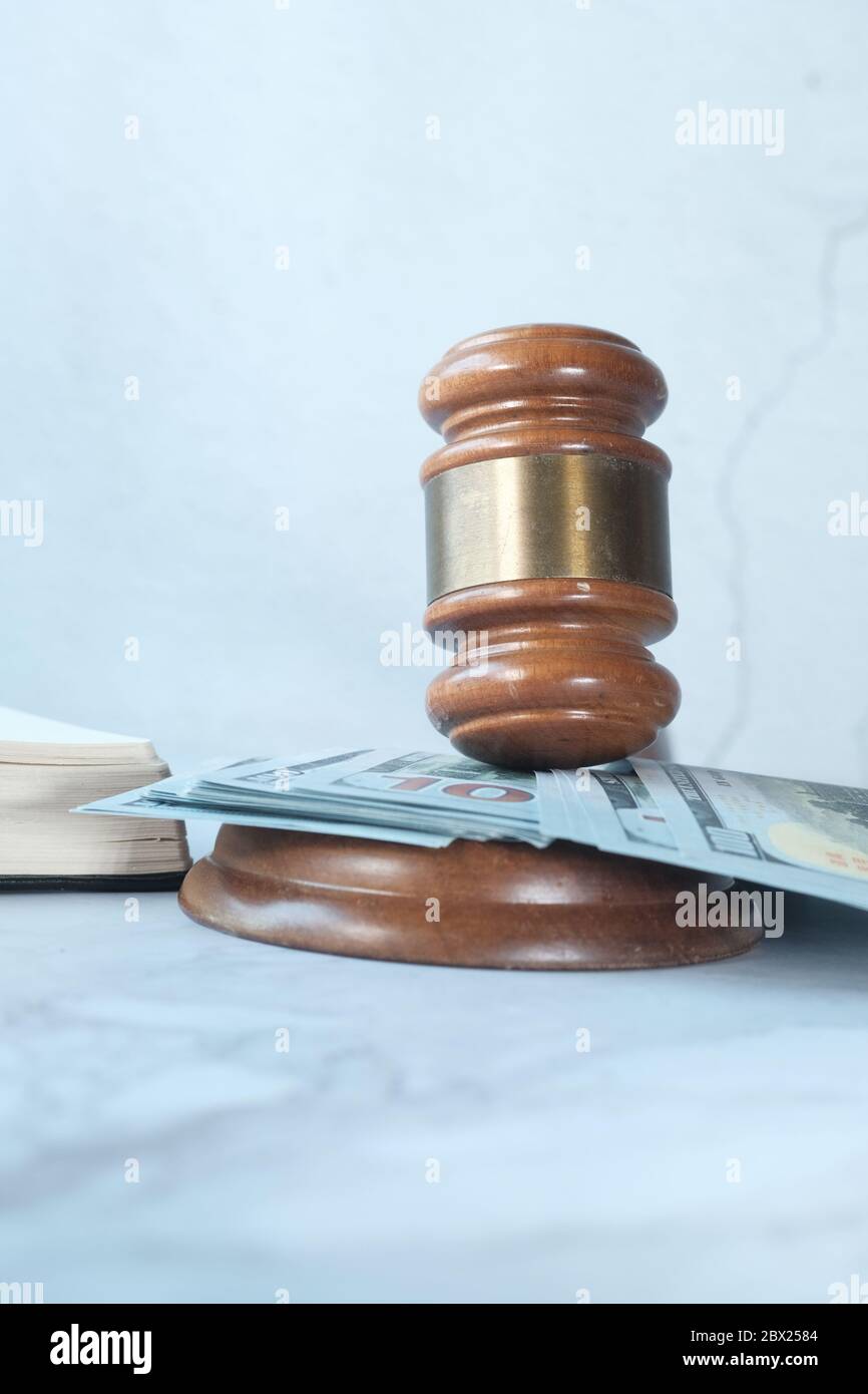 Close up of gavel, book and cash on table  Stock Photo
