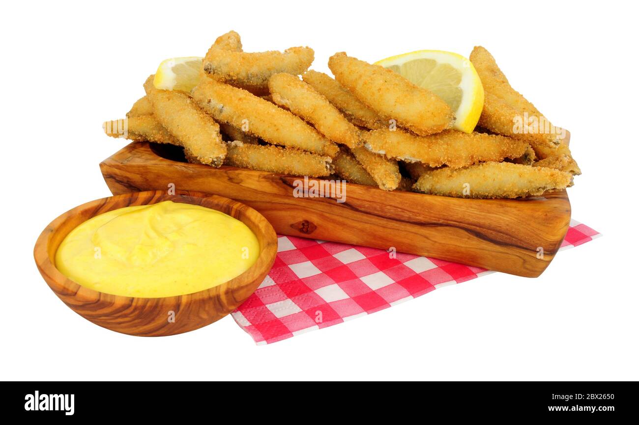 Fried bread crumb covered whitebait fish with mayonnaise dip in an olive wood dish isolated on a white background Stock Photo
