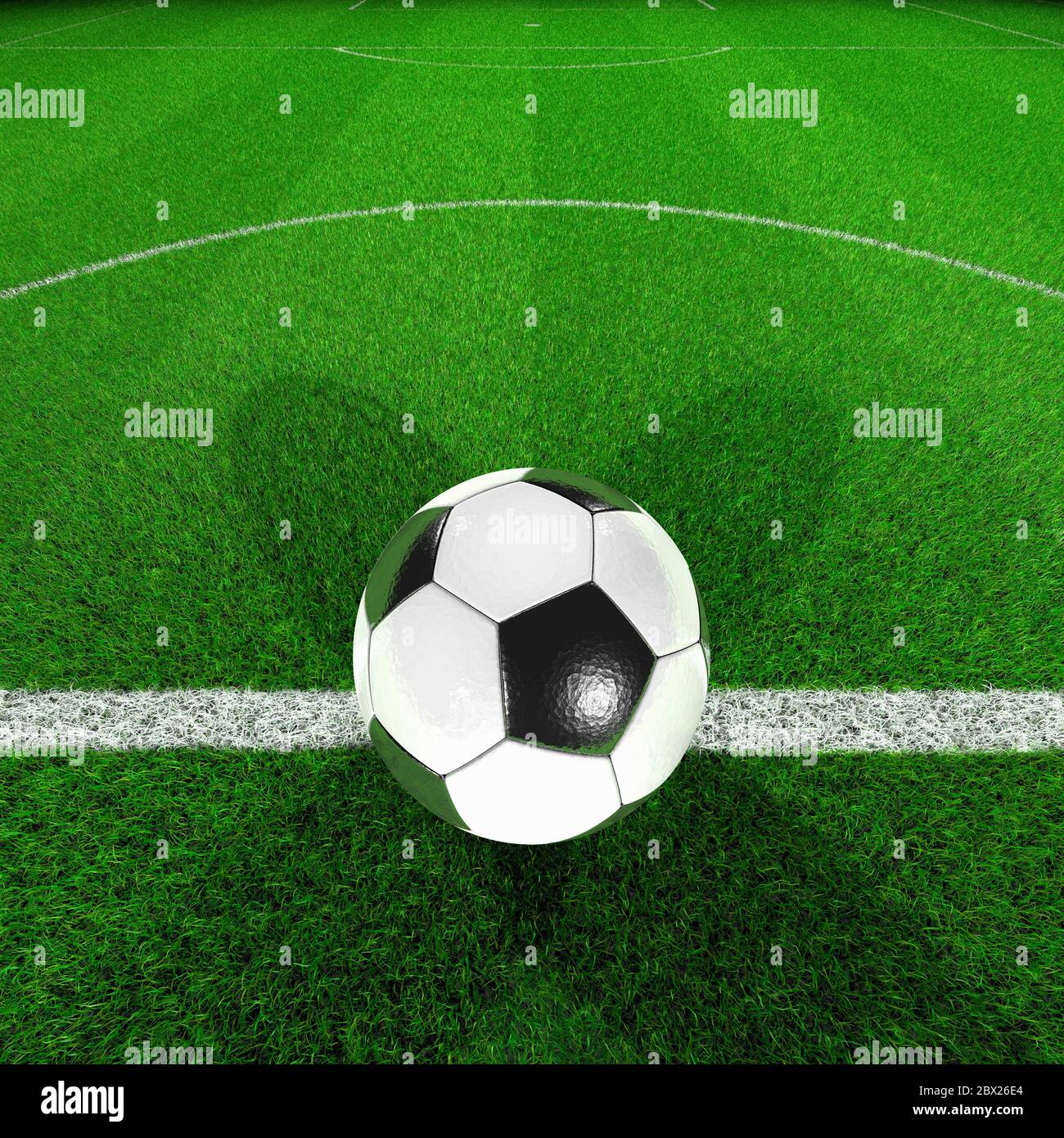 Football pitch. Ball on centre spot centre circle grass. Floodlit, night. Close up.Kick off. Stock Photo