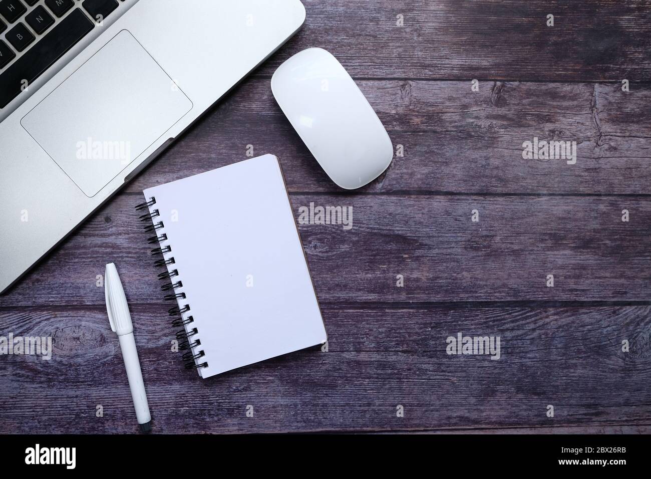 Top view of laptop, notepad and computer mouse on table  Stock Photo