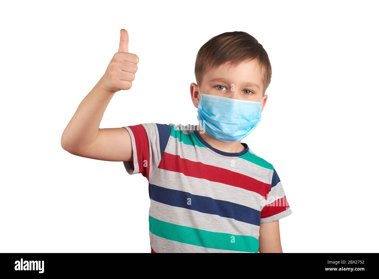 Young teen boy wearing medical mask and shows thumbs up Wearing a ...