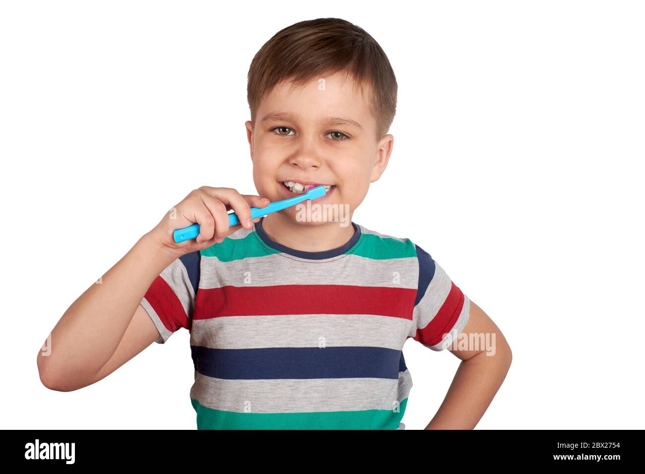 Smiling boy brushes his teeth, isolated on a white background Stock