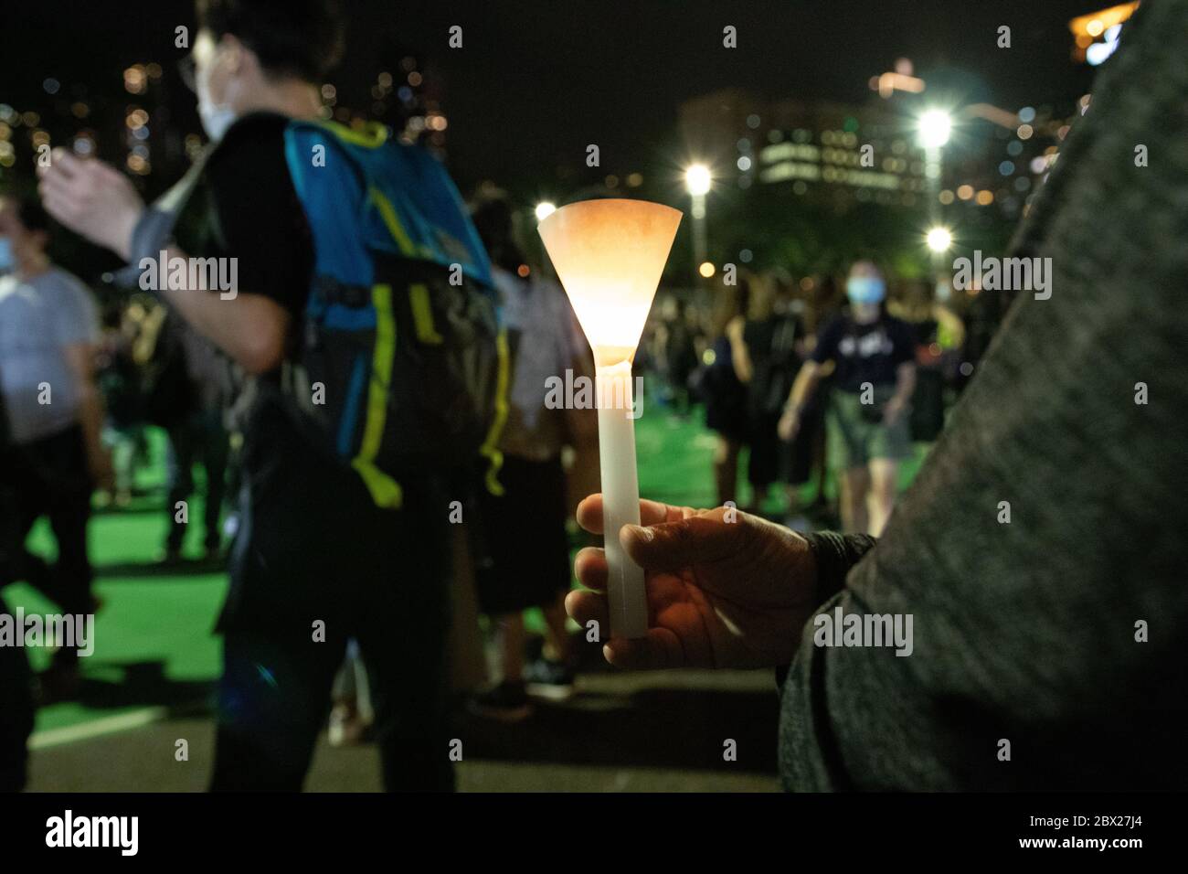 Causeway Bay, Hong Kong. 04, June, 2020. Vigil attendee holds candle as thousands defy pan for peaceful protest in Hong Kong's Victoria park on the anniversary of the Tiananmen Square massacre.  © Danny Tsai / Alamy Live News Stock Photo