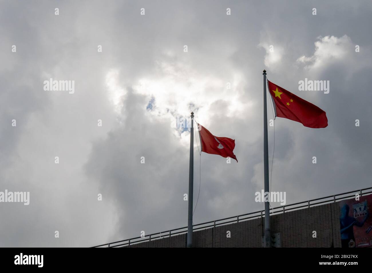 Causeway Bay, Hong Kong. 04, June, 2020. Chinese and Hong Kong Flags flying together on June 4th as legislature passes law incriminating slander of Chinese national anthem.  © Danny Tsai / Alamy Live News Stock Photo