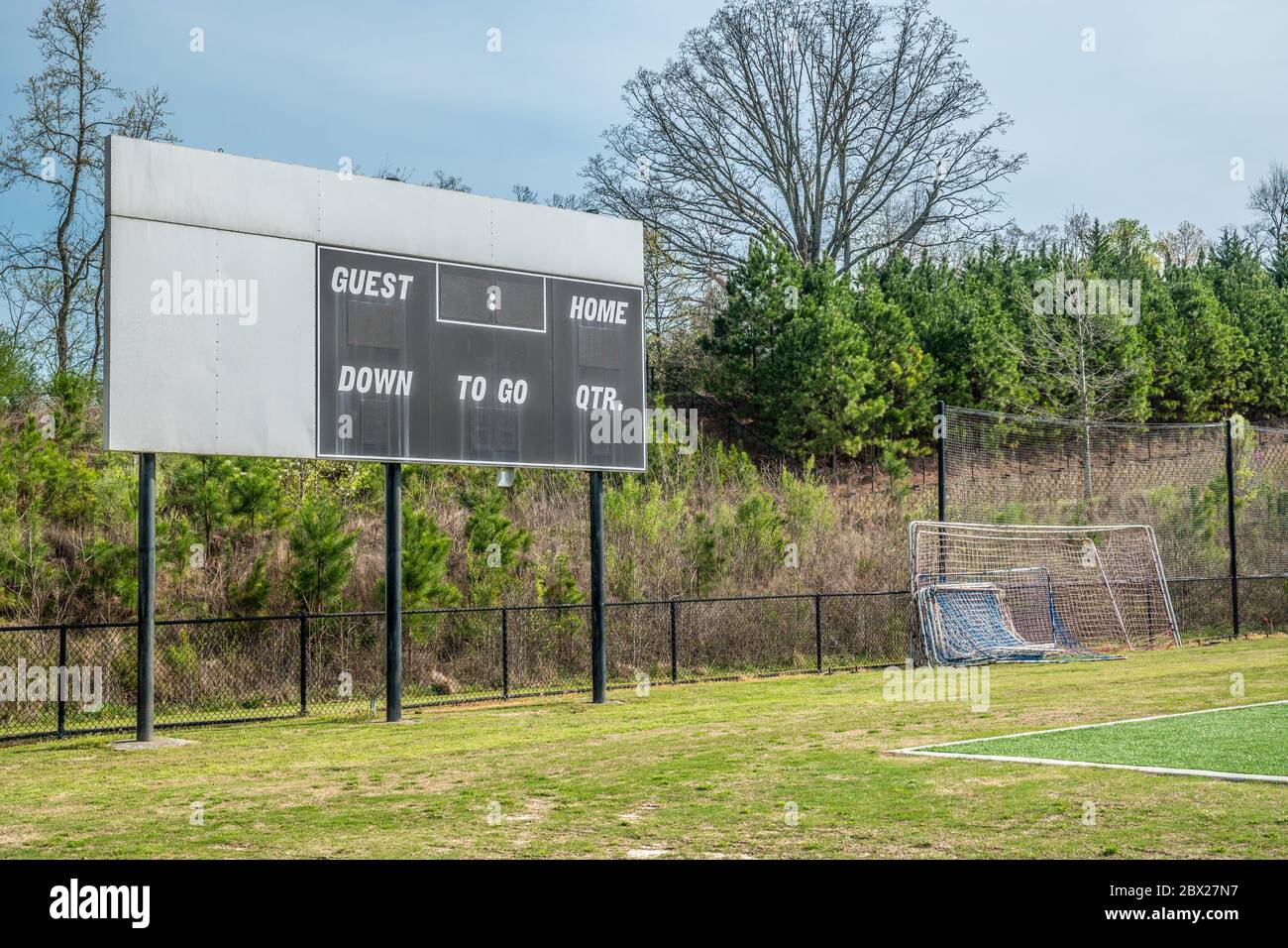 Blank and unused scoreboard in a soccer field in a park with goal nets