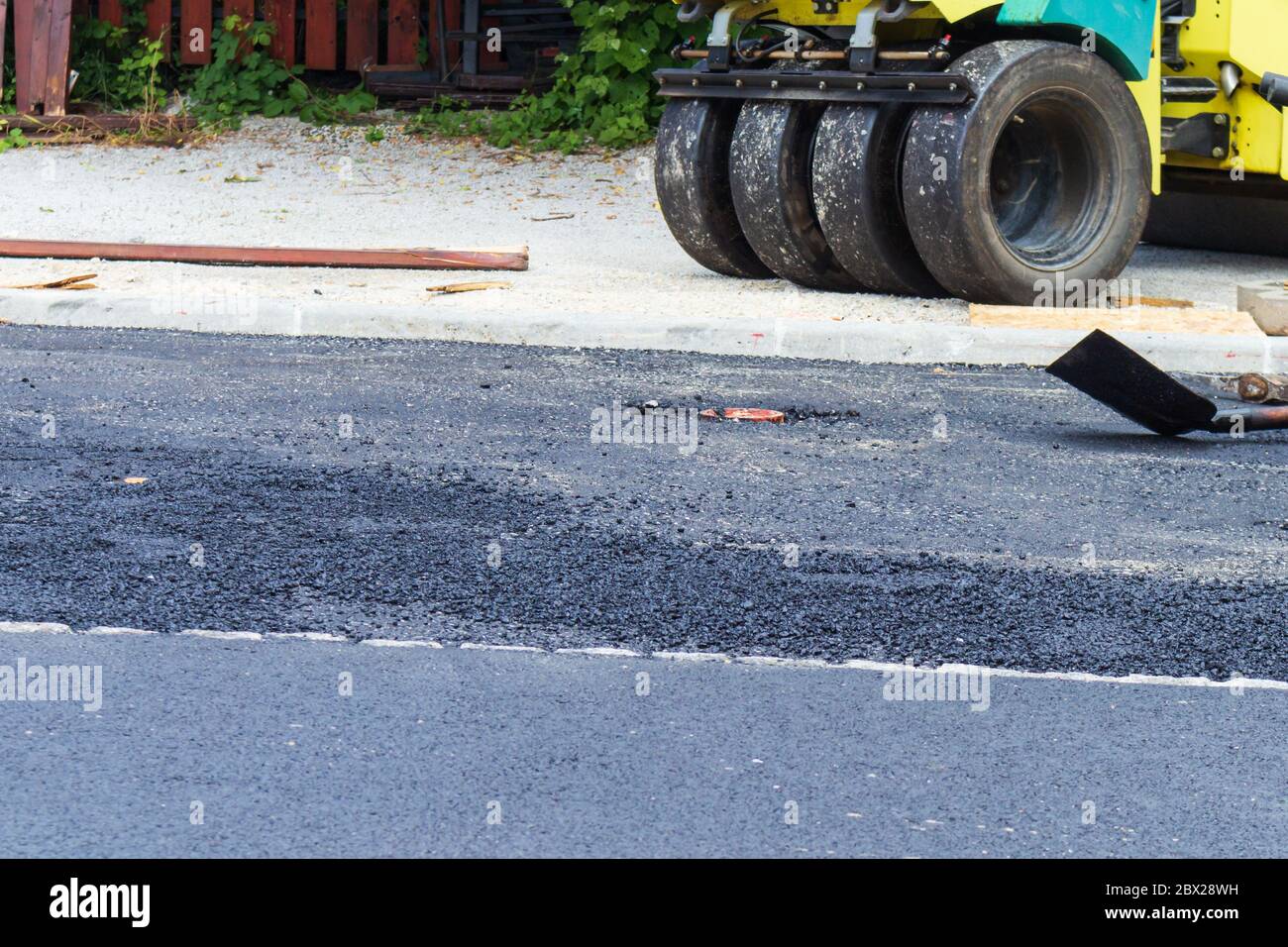 Fresh black asphalt on new street road. Construction at work. Stock Photo
