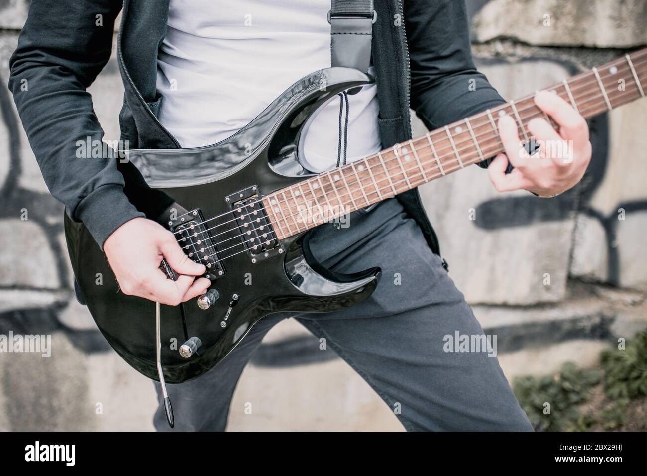 Technique of playing the electric guitar a man playing outdoors