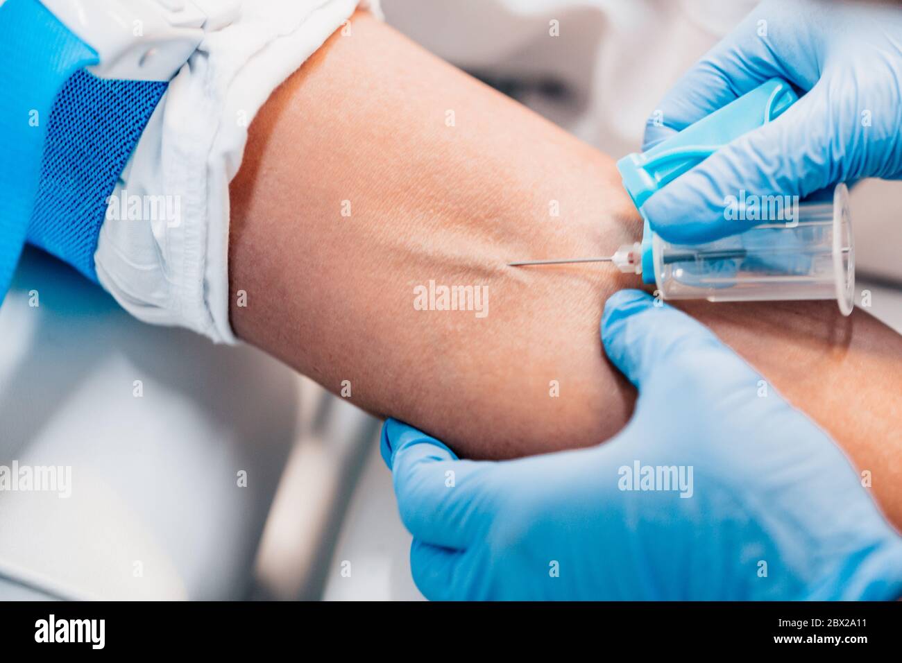Close up needle in vein - blood draw - blood donation - blood transfusion Stock Photo