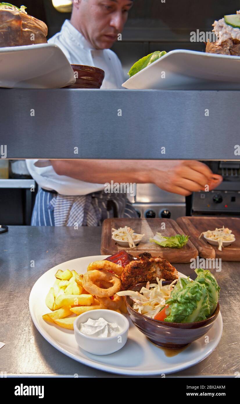pub food ready to be served in commercial kitchen at British pub Stock Photo