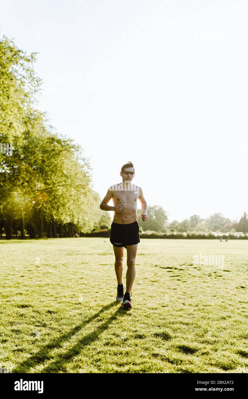 Male Running In The Park without a shirt Stock Photo Alamy