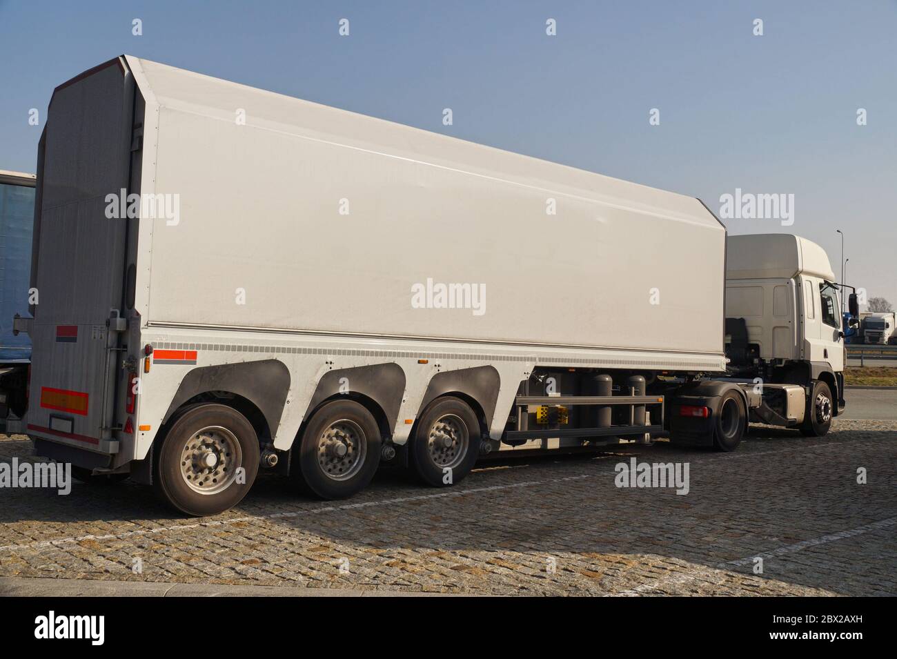 A truck with a specialist trailer for the transport of concrete slabs and glass. Stock Photo