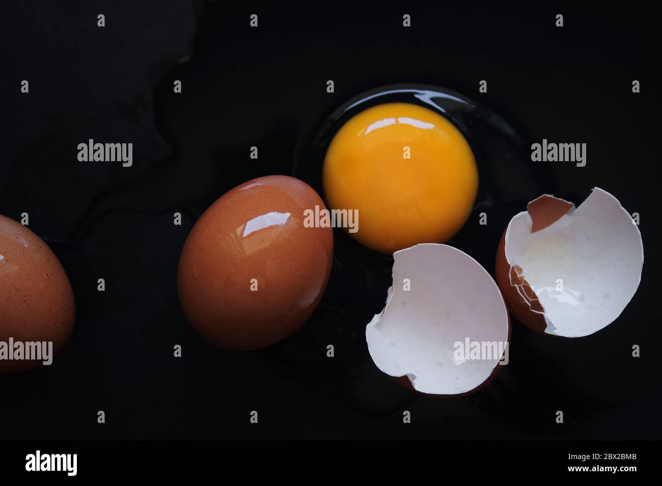 Broken egg on the black floor Stock Photo