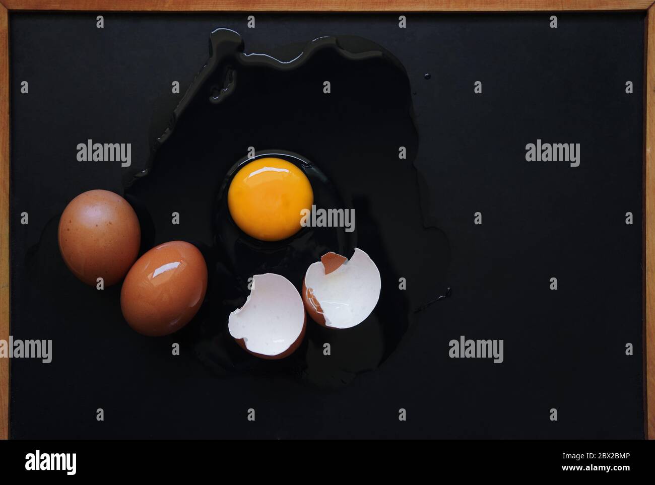 Broken egg on the black floor Stock Photo