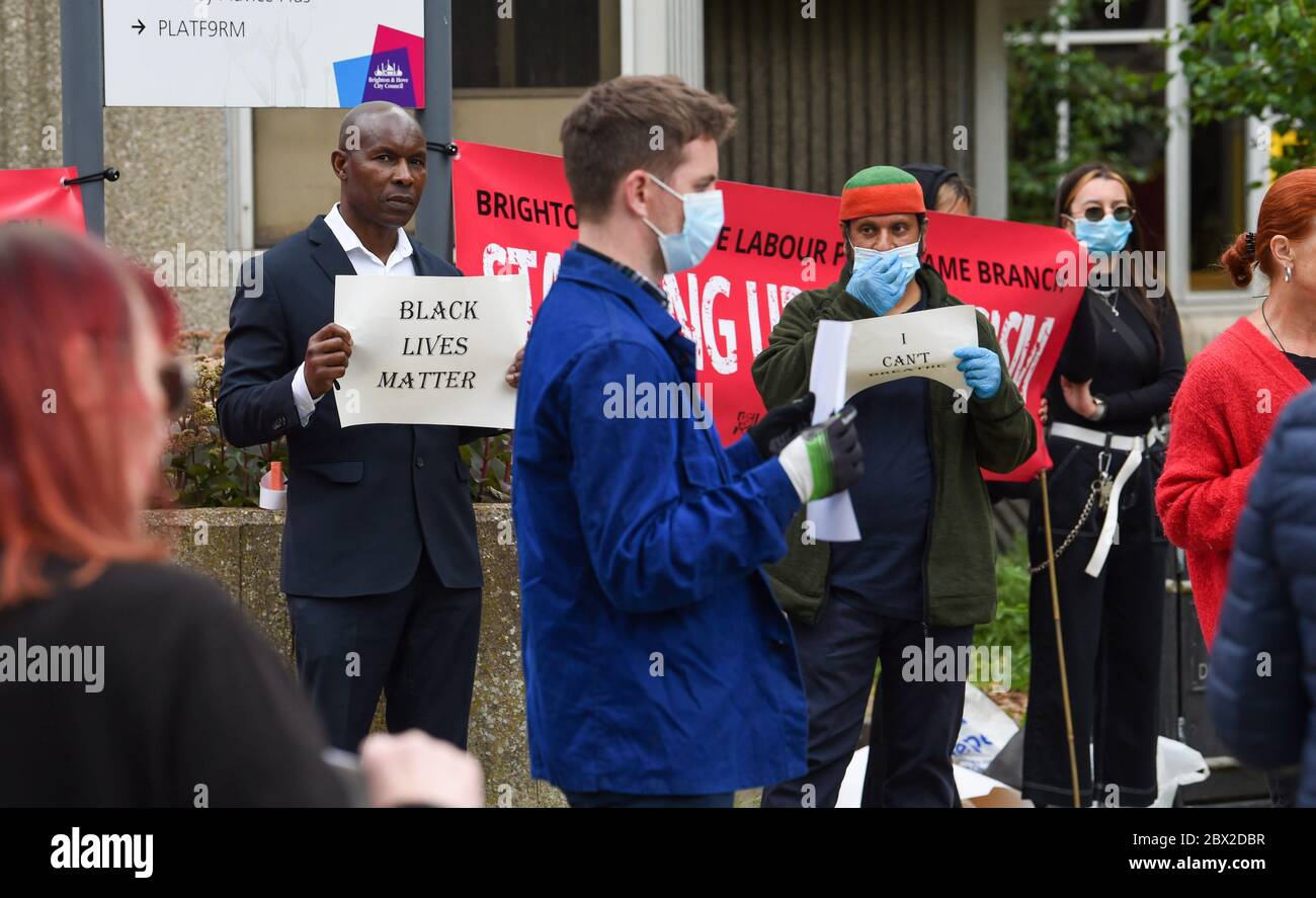 Brighton UK 4th June 2020 - People take part in the peaceful  Black Lives Matter anti racism rally outside Hove Town Hall this evening . There have been protests throughout America , Britain and other countries since the death of George Floyd while being arrested by police in Minneapolis on May 25th : Credit Simon Dack / Alamy Live News Stock Photo