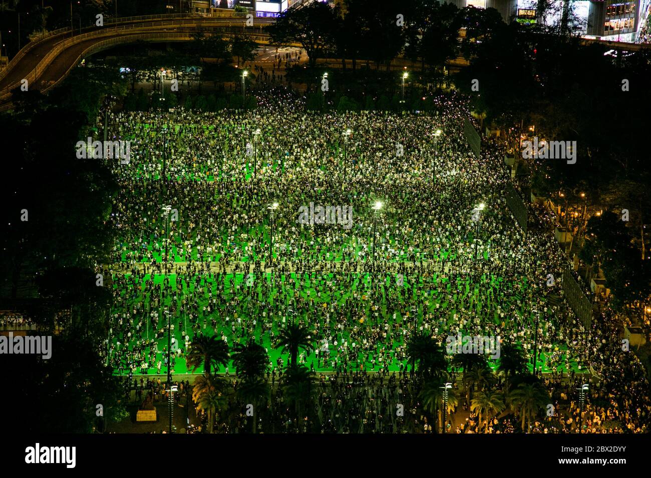 An overview of thousands of citizens gathered at Victoria Park. Thousands of Hong Kong People defy the public gathering ban imposed by government following the Coronavirus (COVID-19) crisis situation and gather at Victoria Park for Tiananmen Anniversary. Stock Photo