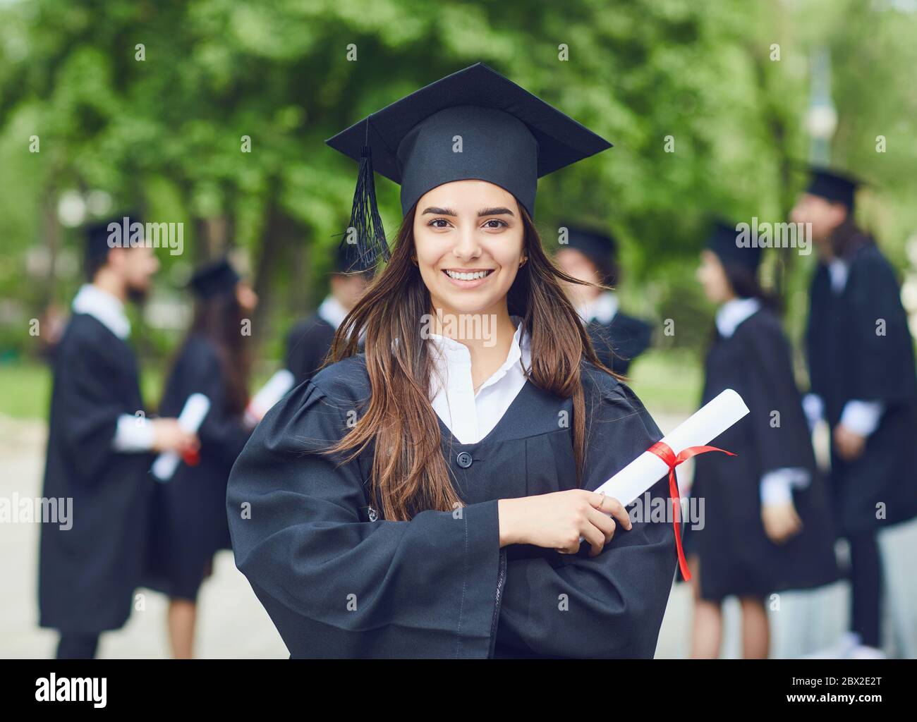 A young female graduate against the background of university graduates  Stock Photo - Alamy