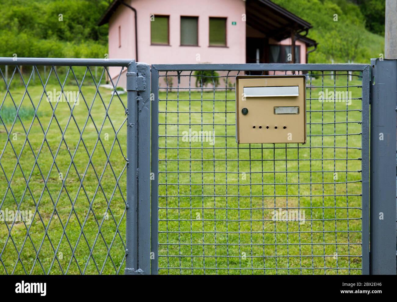 Mailbox On The Fence Of The House In The Background A Beautiful House Stock Photo Alamy
