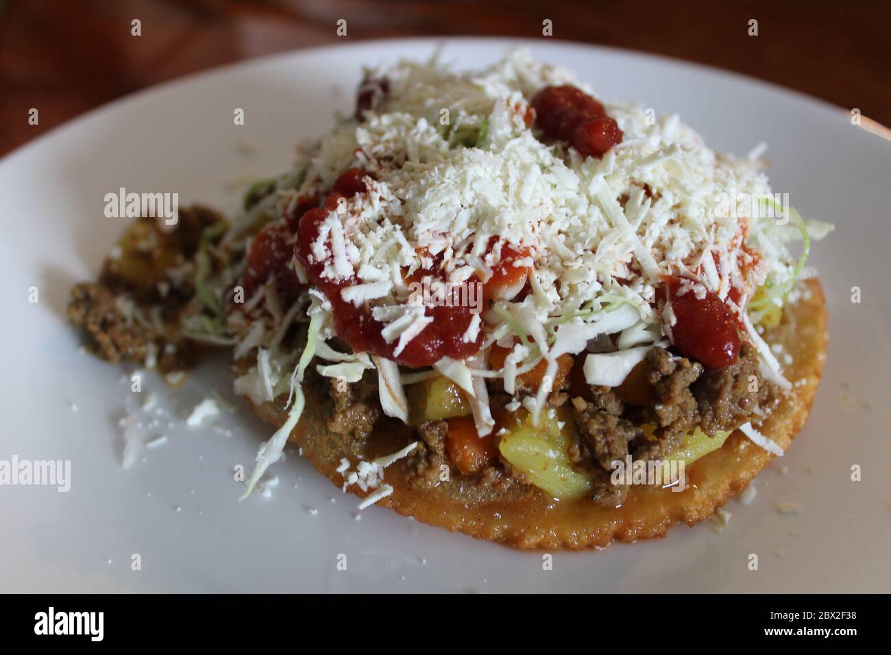Enchilada or tostada from Honduras with carne molida, potatoes, carrots