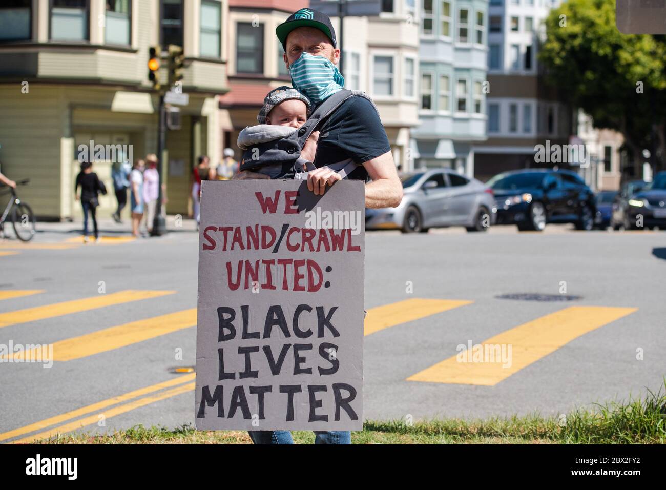 SAN FRANCISCO, CA- JUNE 3: A father and child protest at Mission High in San Francisco, California on June 3, 2020 after the death of George Floyd. (Photo by Chris Tuite/ImageSPACE) Stock Photo