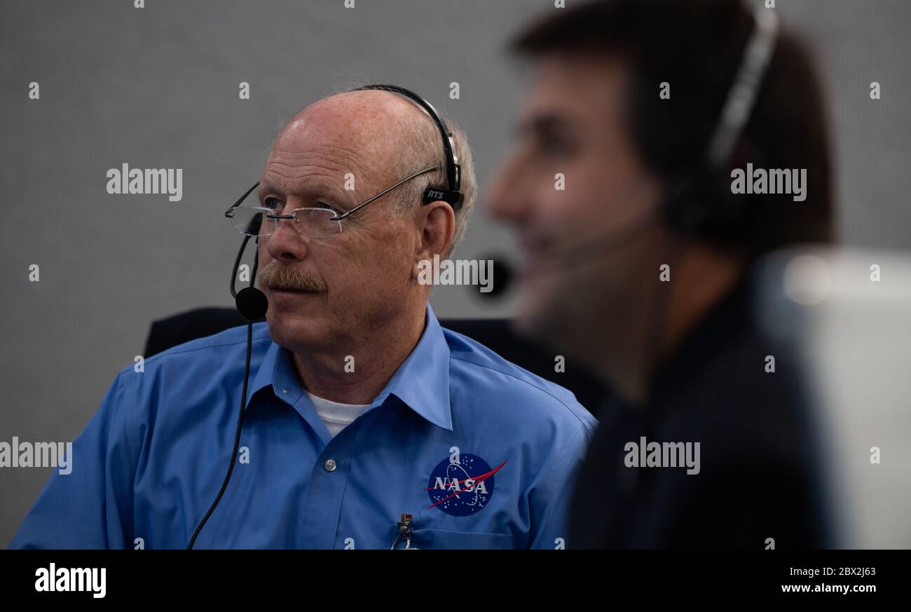 Ken Bowersox, acting Associate Administrator for Human Exploration and Operations Mission Directorate, monitors the docking of the Crew Dragon spacecraft with the International Space Station from mission control at the Kennedy Space Center May 31, 2020 Cape Canaveral, in Florida. The spacecraft with astronauts Douglas Hurley and Robert Behnken is the first commercial manned spacecraft to complete the journey. Stock Photo