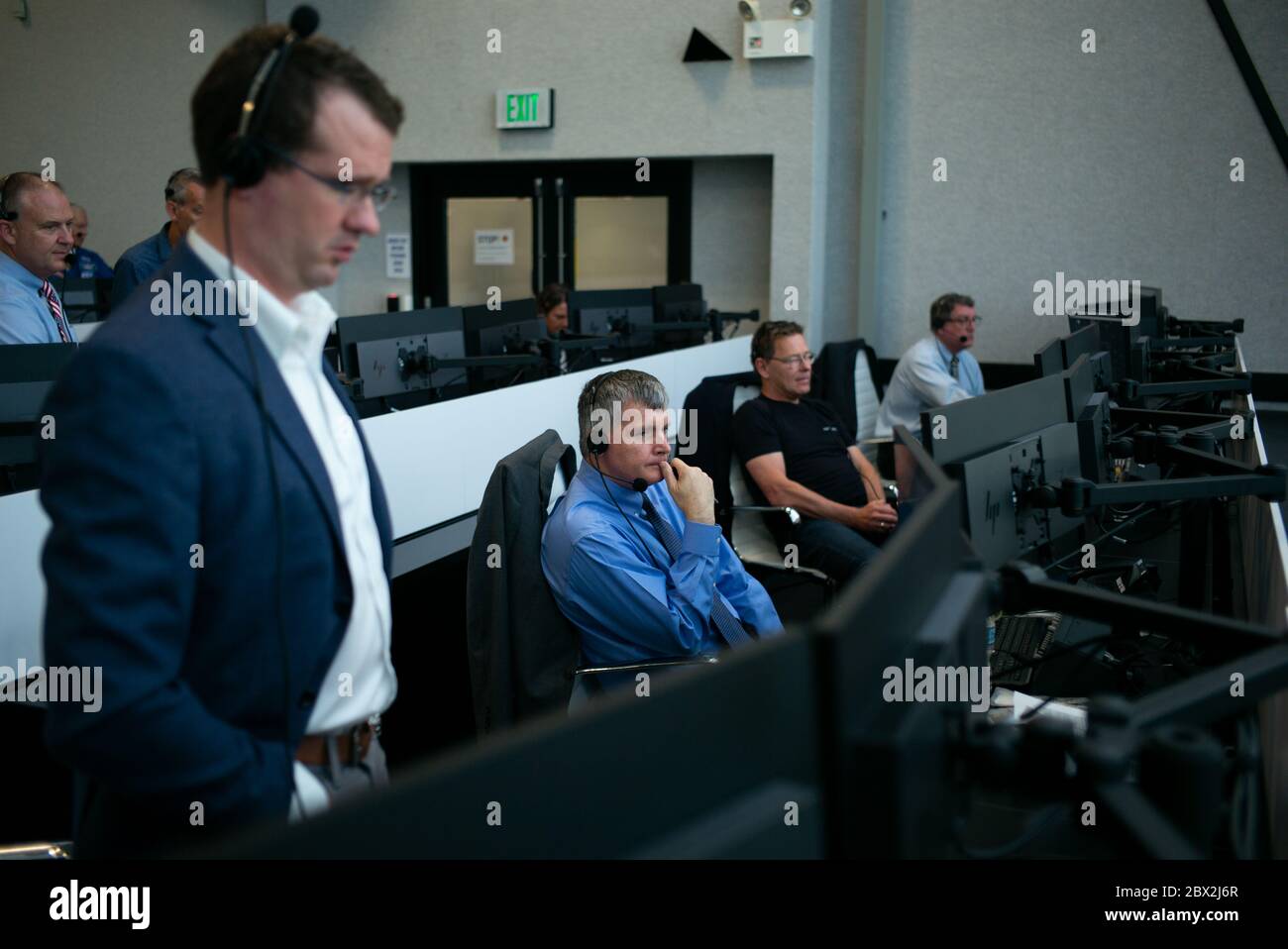 Steve Stich, deputy manager of the NASA Commercial Crew Program, monitors the launch of a SpaceX Falcon 9 rocket carrying the company's Crew Dragon spacecraft on the Demo-2 mission with NASA astronauts Douglas Hurley and Robert Behnken onboard, Saturday, May 30, 2020, in  firing room four of the Launch Control Center at NASA’s Kennedy Space Center in Florida. NASA’s SpaceX Demo-2 mission is the first launch with astronauts of the SpaceX Crew Dragon spacecraft and Falcon 9 rocket to the International Space Station as part of the agency’s Commercial Crew Program. The test flight serves as an end Stock Photo