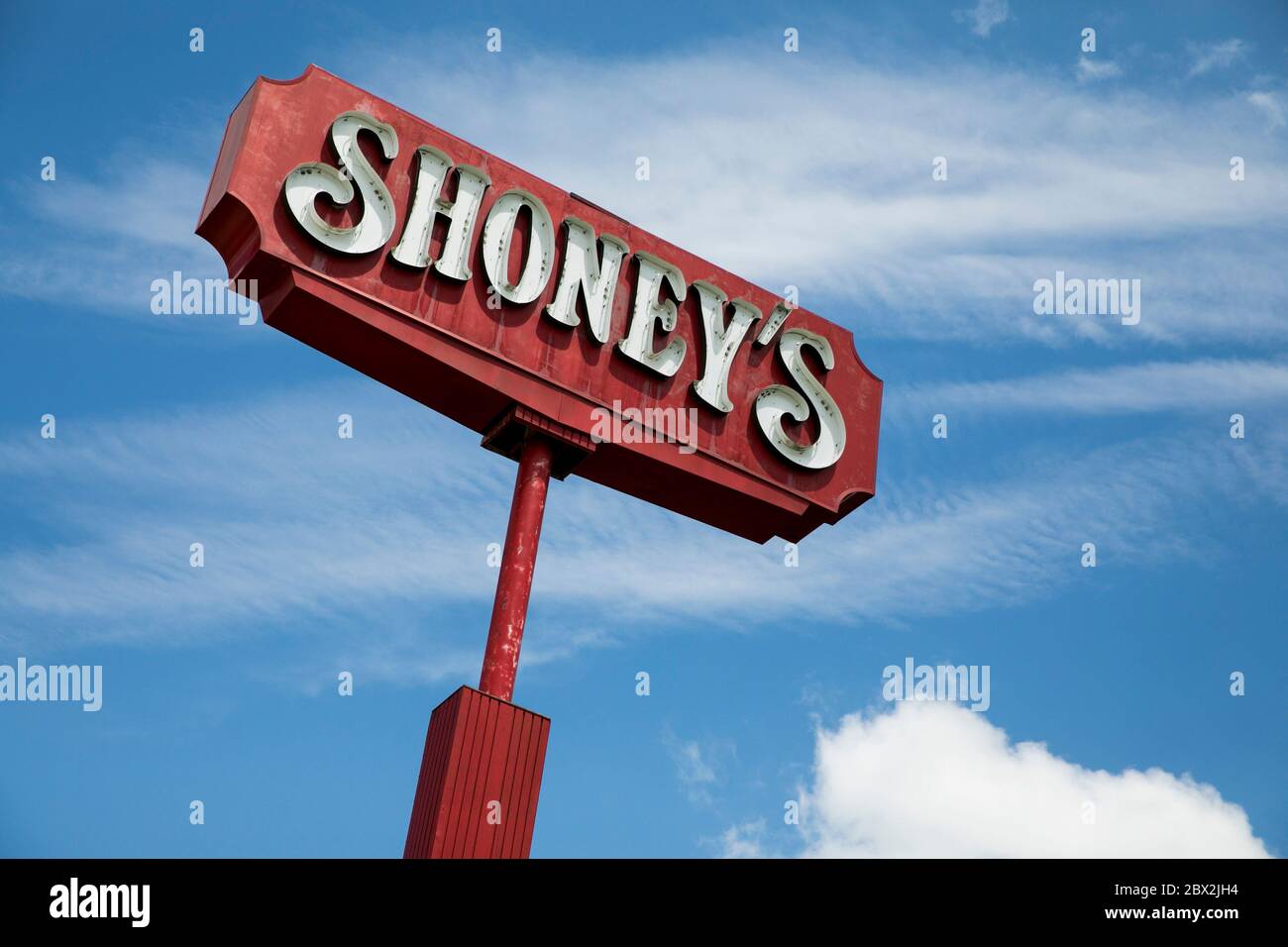 A logo sign outside of a Shoney's restaurant location in Sutton, West
