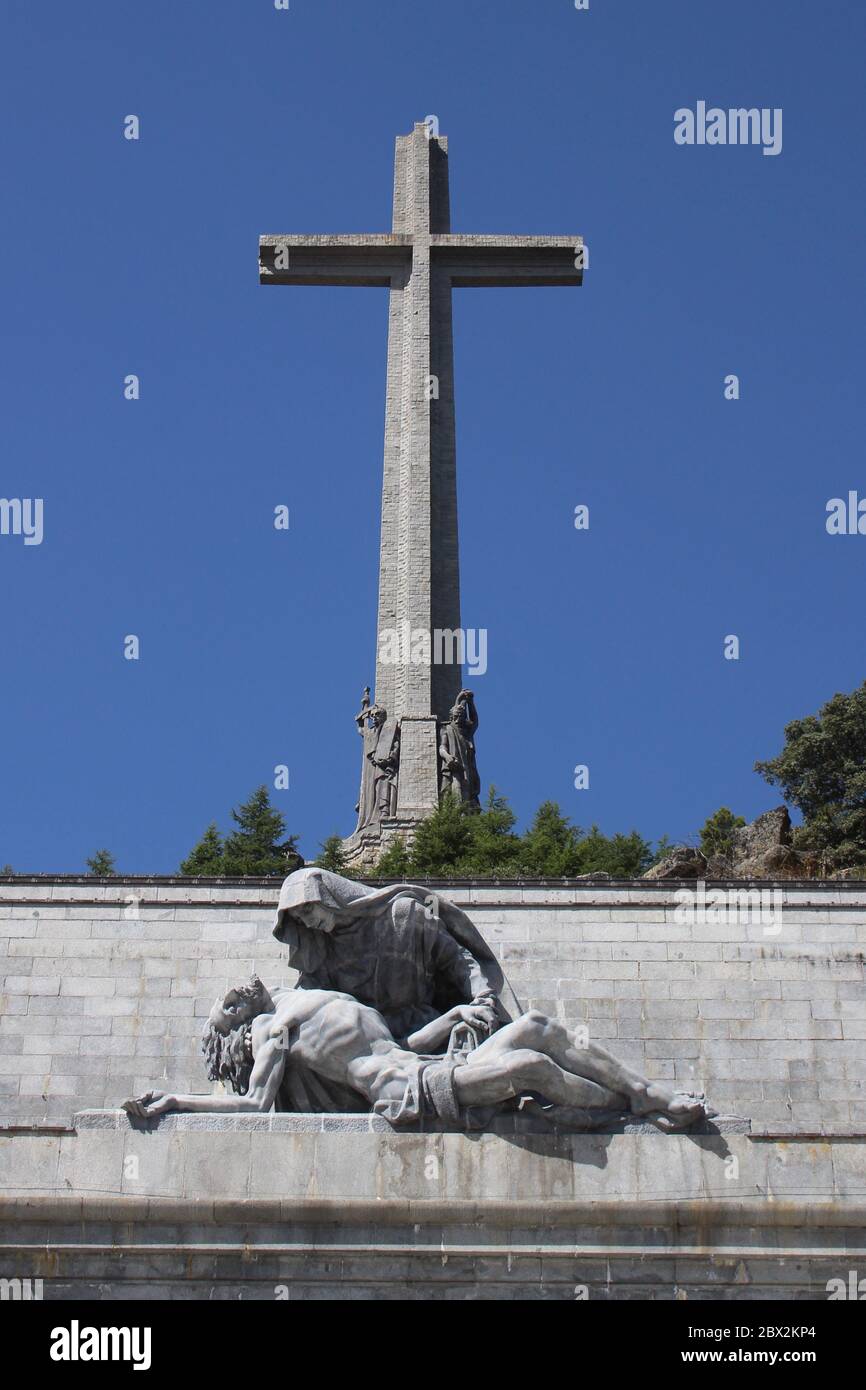 Valle de Los Caidos (Valley of the fallen) Huge cross and statue of Mary holding Jesus in strong sunlight Madrid Spain Stock Photo