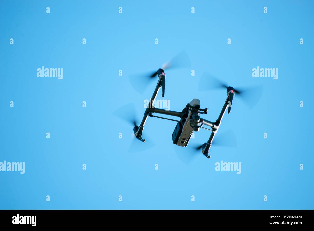 Quadcopter drone with camera hovers overhead during a protest march on May 31 in Louisville, Kentucky. Stock Photo