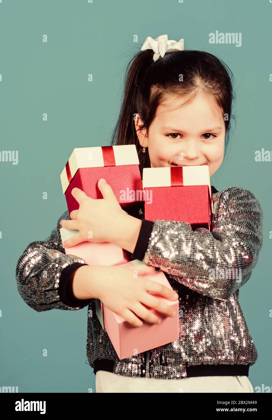 Shopping day. Child carry lot gift boxes. Surprise gift box. Birthday wish list. World of happiness. Only for me. Special happens every day. Girl with gift boxes blue background. Black friday. Stock Photo