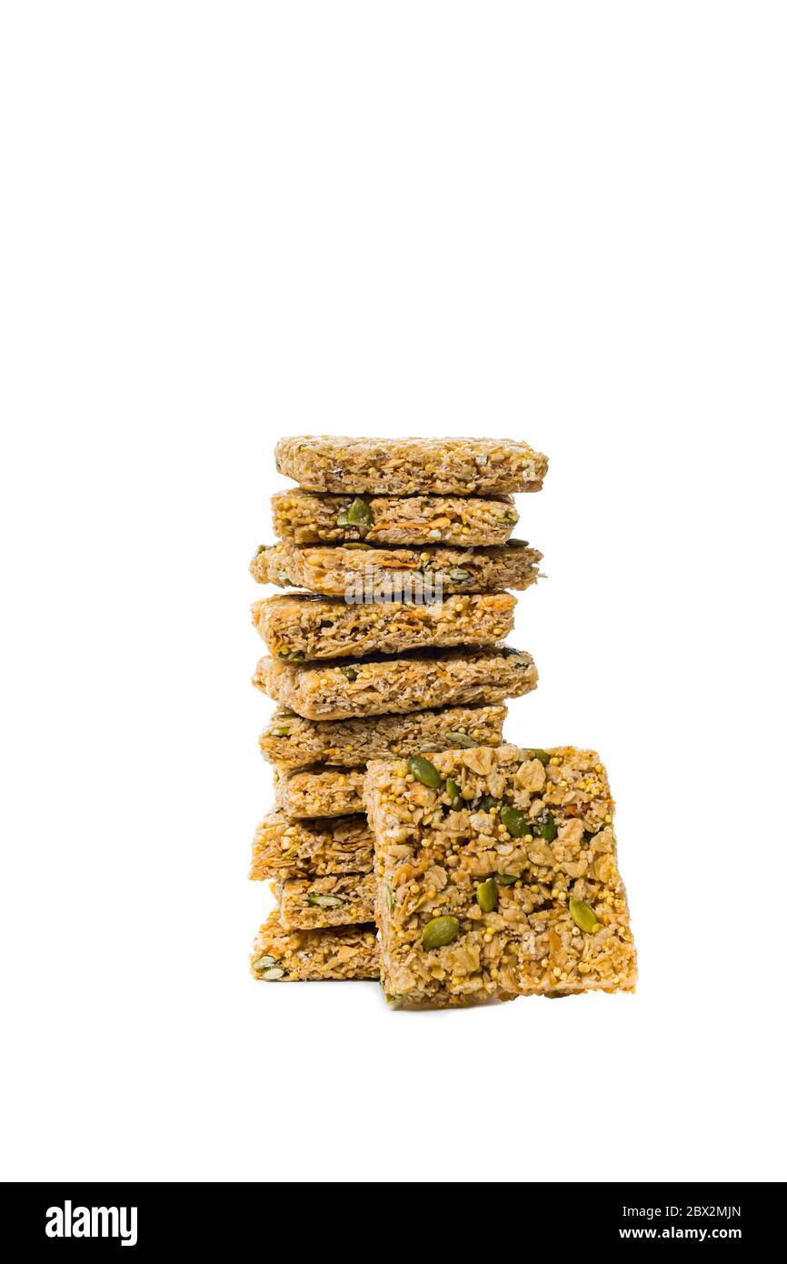 Multigrain Cereal Crunchy Squares Bars with Pumpkin Seeds Background. Healthy Bar Snack on White Background Stock Photo